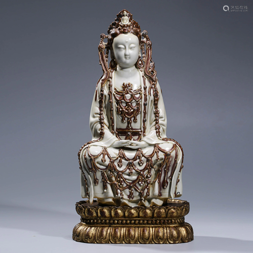 A COPPER RED PORCELAIN GUAN YIN WITH STAND