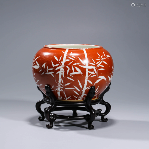 A CORAL RED BAMBOO PORCELAIN JAR WITH STAND