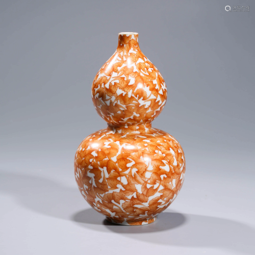 AN IRON RED GOURD SHAPED PORCELAIN VASE