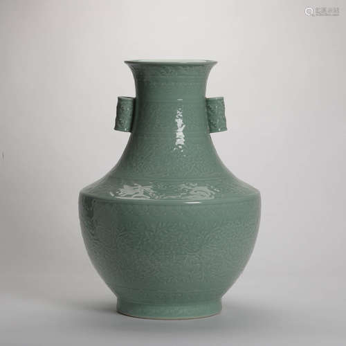 A Pea Green Carved Porcelain Guan Er Vase