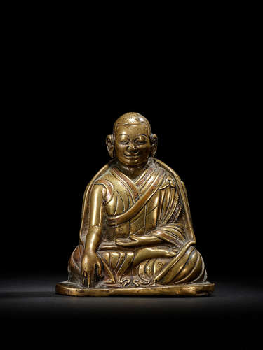 A COPPER INLAID BRASS FIGURE OF A KAGYU HIERARCH CENTRAL TIBET, CIRCA 13TH CENTURY