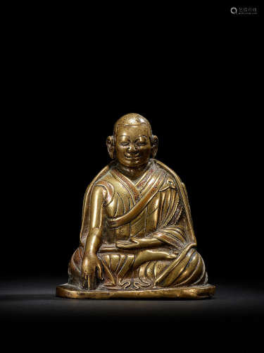 A COPPER INLAID BRASS FIGURE OF A KAGYU HIERARCH CENTRAL TIBET, CIRCA 13TH CENTURY
