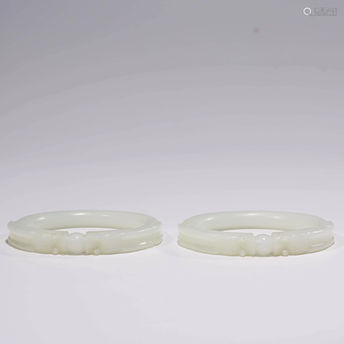 A PAIR OF WHITE JADE DRAGON BRACELETS