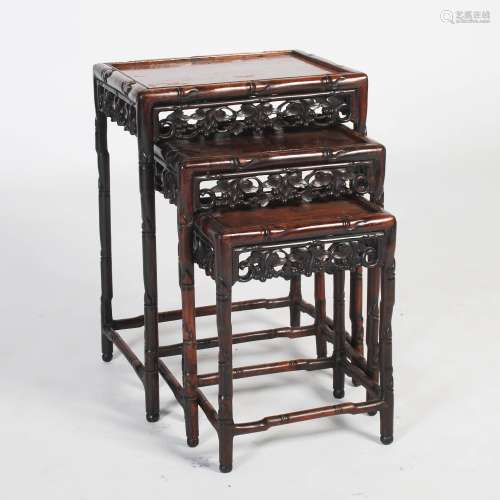 A nest of three Chinese dark wood occasional tables, late 19th/early 20th century, the rectangular