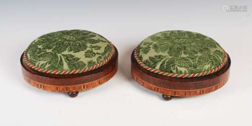 A pair of 19th century walnut and parquetry inlaid circular footstools, with green stuff over