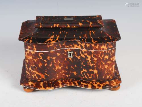 A 19th century tortoiseshell tea caddy, the hinged rectangular top with serpentine front, opening to