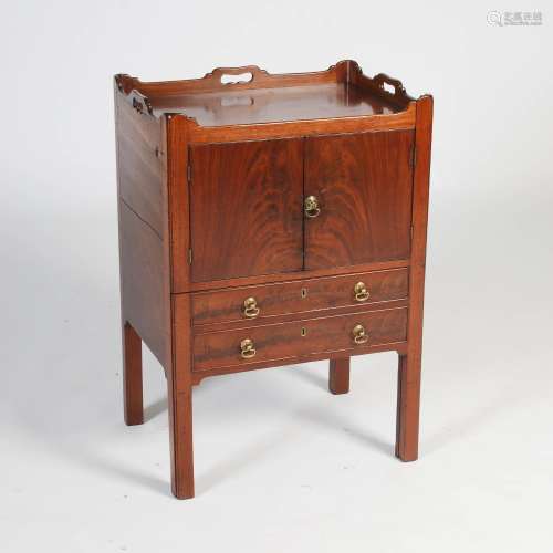 A George III mahogany tray top commode, the rectangular top with three quarter gallery and pierced