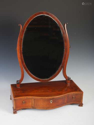 A 19th century mahogany boxwood and ebony lined dressing table mirror, the oval mirror plate