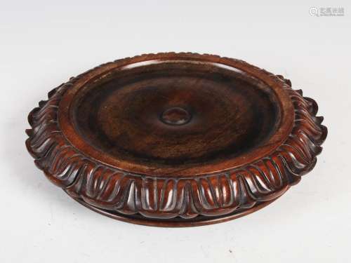 A Scottish Regency mahogany coaster by James Mein, Kelso, of circular form with foliate carved edge,