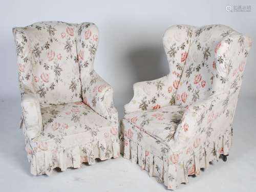 A pair of late 19th century mahogany wing armchairs, the upholstered back, arms and seats raised