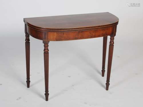 A George III mahogany and boxwood lined demi lune tea table, the hinged top above a plain frieze,