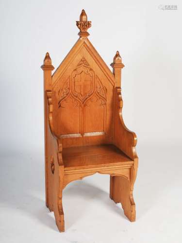 An early 20th century oak Gothic altar chair, the triangular panelled back centred with a relief