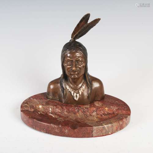 An early 20th century marble and cold painted bronze cendrier, mounted with the bust of a native