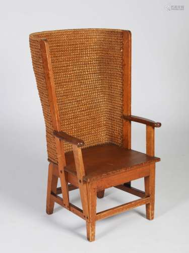 A late 19th/early 20th century Scottish pine Orkney chair, with woven back and scroll details to the