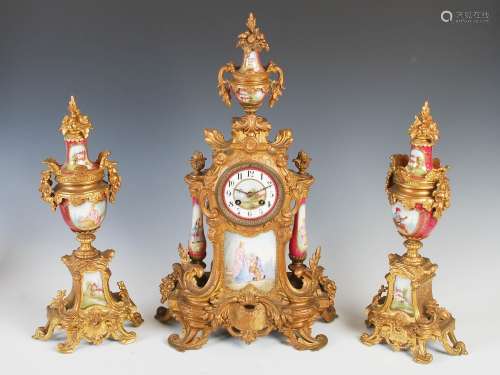 A late 19th century French gilt metal and porcelain mounted clock garniture, the clock with circular