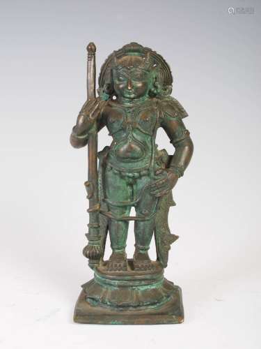 An Indian patinated bronze figure of a warrior, modelled standing on lotus throne and square