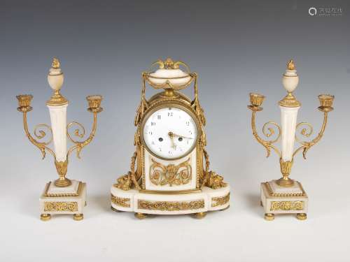 A late 19th century French gilt and white marble clock garniture, the clock with circular convex