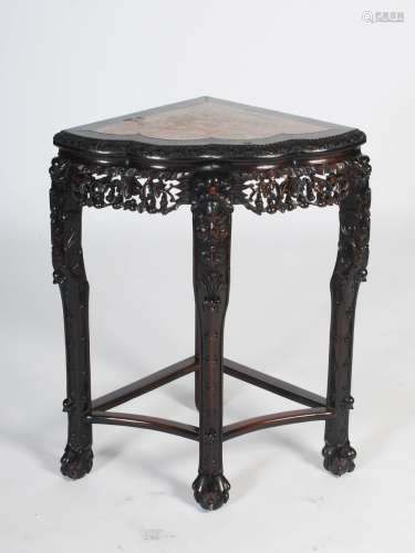 A Chinese dark wood corner table, Qing Dynasty, the shaped rectangular top with a red and white