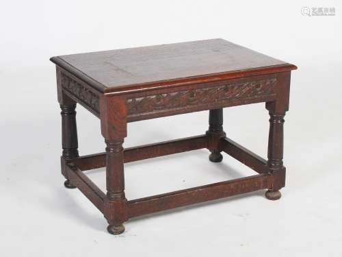 A late 19th century oak occasional table, the rectangular top above a foliate carved frieze,