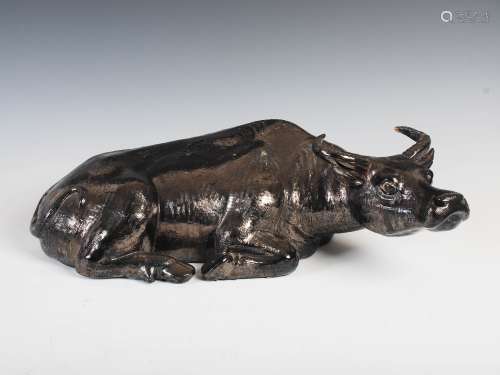 A Chinese porcelain figure of a recumbent ox, late 19th/early 20th century, covered in a silvered