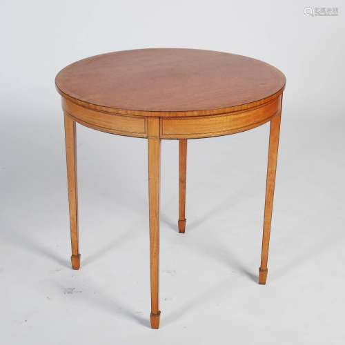 An Edwardian satinwood and ebony lined occasional table, the circular top above a plain frieze,