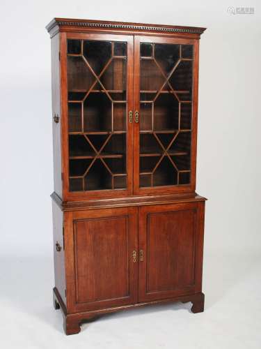 A George III mahogany bookcase, with moulded cornice and dentil frieze above a pair of astragal