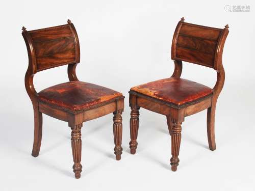 A pair of William IV mahogany and brass inlaid hall chairs, the convex and concave uprights