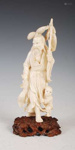 A Japanese ivory okimono of fisherman and boy, Meiji Period, signed, on carved wood stand, overall