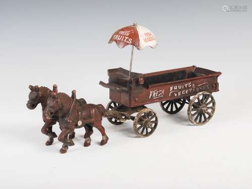 An early 20th century novelty cast metal and cold painted fresh fruit and vegetable horse and cart