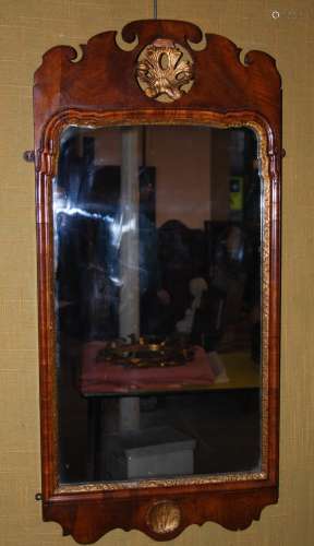 A 19th century George II style walnut and parcel gilt wall mirror, the fret cut frieze centred