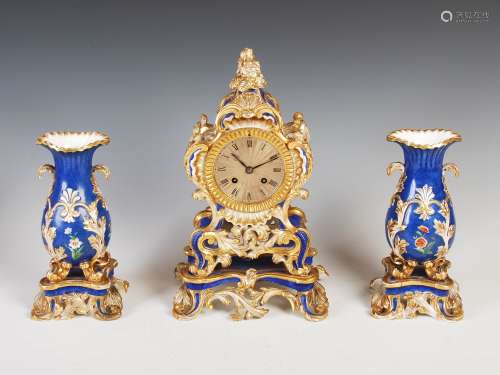 A late 19th century Paris Ed Honore porcelain clock garniture in the Rococo style, the clock with