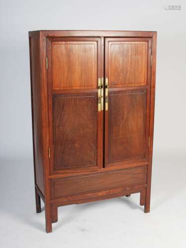 A Chinese dark wood food cupboard, the rectangular top above two panelled cupboard doors, opening to