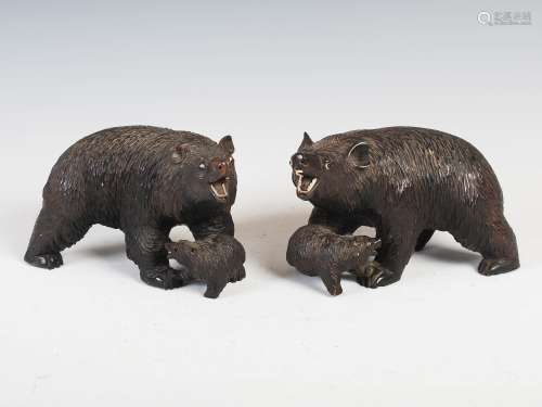 A pair of 19th century Black Forest carved wood bear and cub figures, with inlaid eyes and teeth,