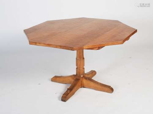 Beaverman - A carved oak octagonal shaped pedestal table, the adzed octagonal top raised on a shaped