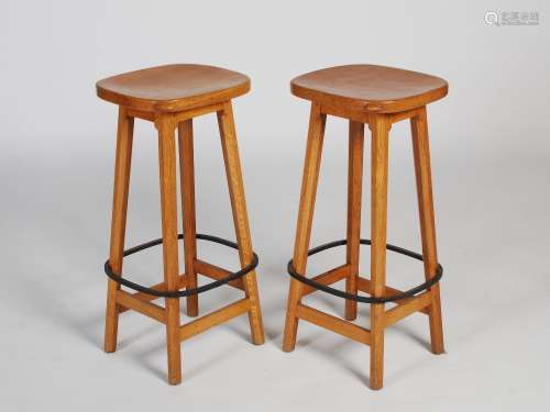 Mouseman - A pair of oak bar stools, the dished rounded rectangular tops raised on four splayed