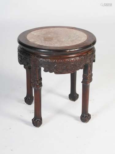A Chinese dark wood urn stand, Qing Dynasty, the circular top with mottled red and white marble