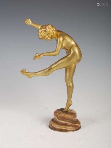 Claire Colinet (1880-1950) - A gilt bronze figure of a nude juggler, on circular stepped marble