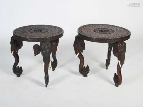 A near pair of late 19th/early 20th century Indian elephant head occasional tables, the circular