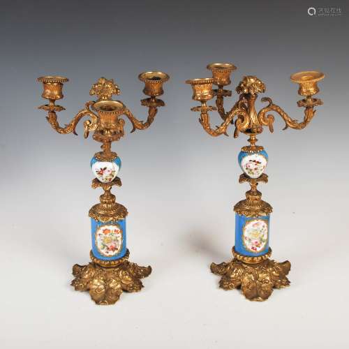 A pair of late 19th century French blue ground porcelain and gilt metal three light candelabra, with