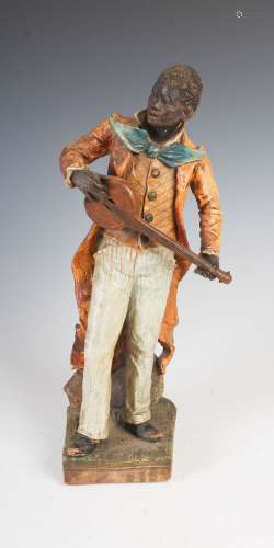 A late 19th/early 20th century cold painted terracotta figure group of a musician, 39.5cm high.