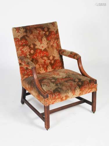 A George III mahogany Gainsborough chair, the velvet upholstered back, arms and seat with brass