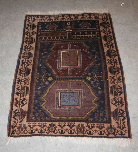 An Afghan Belouch prayer mat, early 20th century, the rectangular blue ground decorated with two