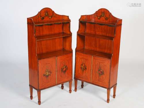 A pair of late 19th/early 20th century painted satinwood waterfall bookcases, the upright backs