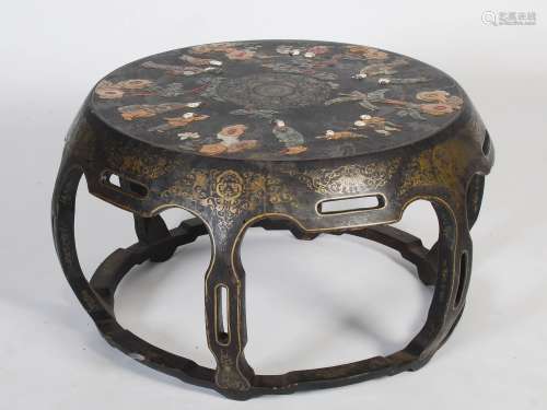 A late 19th/early 20th century Chinese lacquer and hardstone circular low table, the top centred