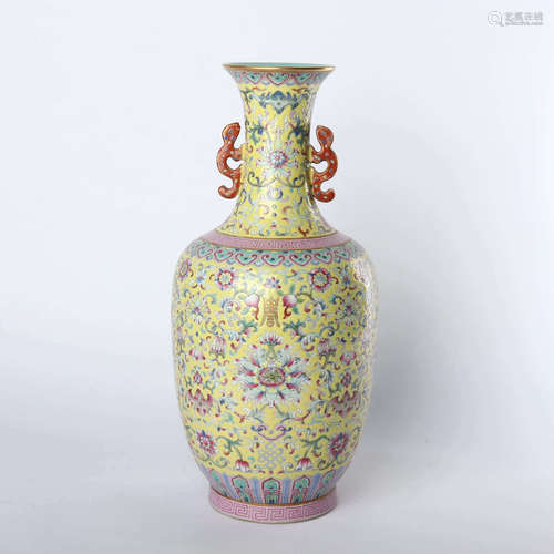 Double eared vase with flower pattern of yellow ground pink lotus in the middle of Qing Dynasty