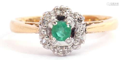 Modern 18ct gold emerald and diamond cluster ring, the round cut emerald four claw set and raised