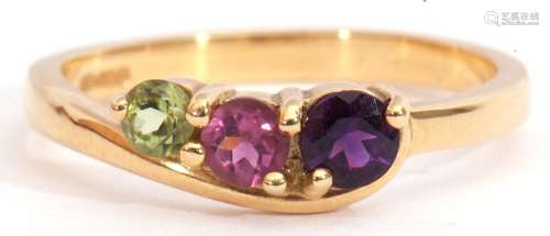 18ct gold gem set ring, a stylised design with graduated round cut amethyst, tourmaline, and