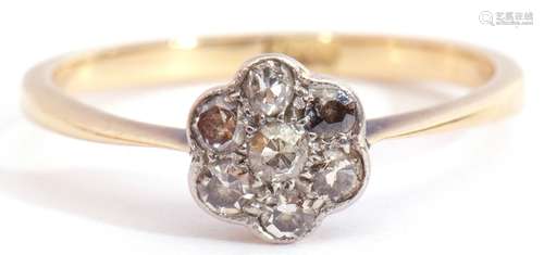 Small diamond cluster ring featuring seven small diamonds in a flowerhead design with millegrain