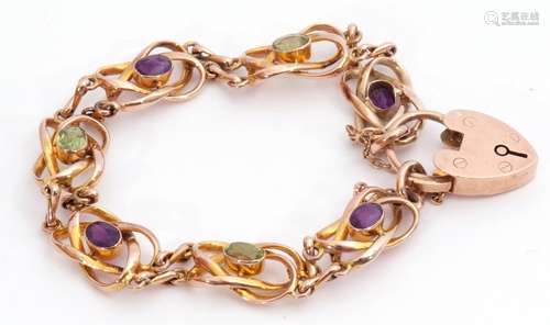 9ct gold amethyst and peridot set bracelet featuring seven open work scroll links, four with oval