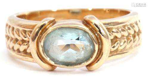 9ct gold and blue stone ring, the oval faceted stone bezel set and raised between rope twist